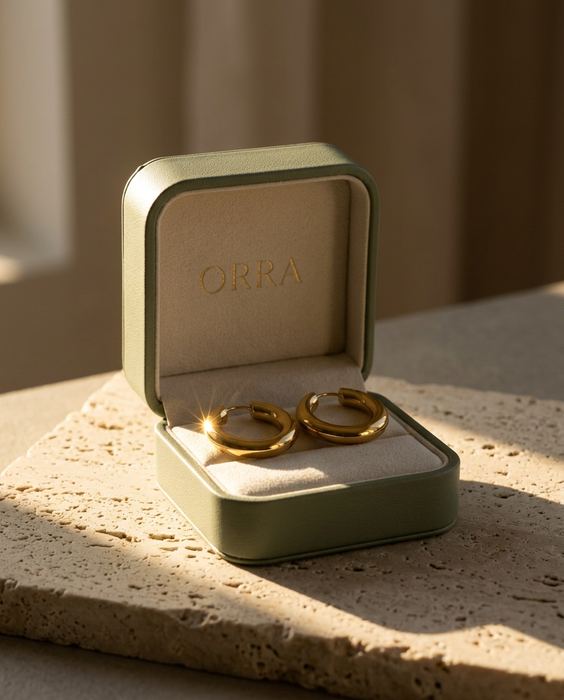 ORRA concept brand, gold hoop earrings: Light — one hard source