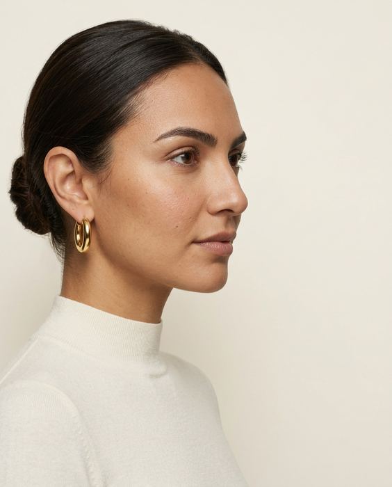 ORRA concept brand, gold hoop earrings: Composition — space for the headline
