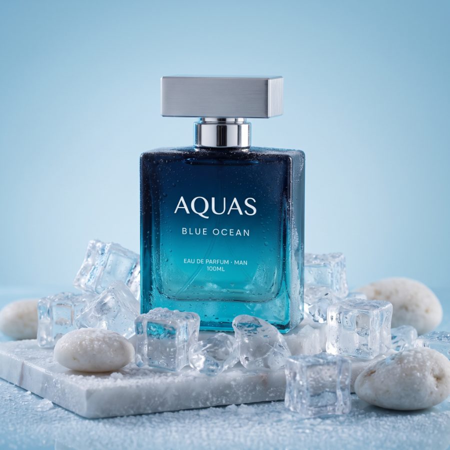 AI generated product photography for Aquas Blue Ocean fragrance brand — wet marble flat lay